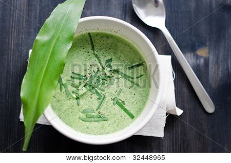 a cup of wild garlic soup with fresh wild garlic