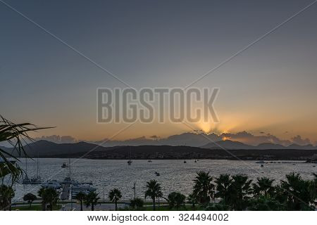 Panoramic View Of The Sun At Sunset On The Background Of The Mountains And The Sea