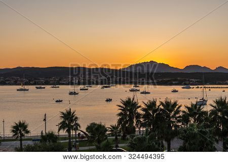 Close-up Of Sunset Against Mountains And Sea With Yachts