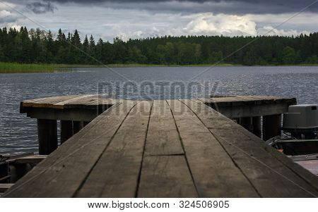 Picturesque View From A Wooden Pier On A Forest Lake In Windy Cloudy Weather. Atmospheric Landscape 