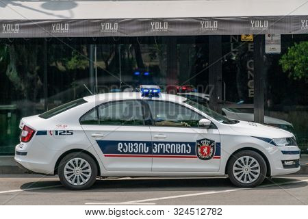 Tbilisi, Georgia - June 27 2019: Police Car On An Asphalt Road Against The Mountains On A Sunny Clea