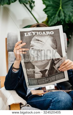 Paris, France - Sep 27, 2019: Woman Reading Le Figaro In Living Room Newspaper Following The Death O