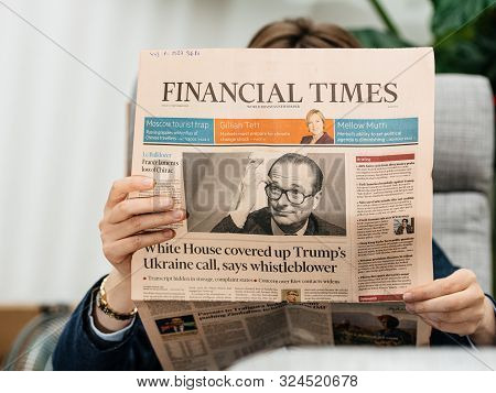 Paris, France - Sep 27, 2019: Woman Reading Financial Times In Living Room Newspaper Following The D