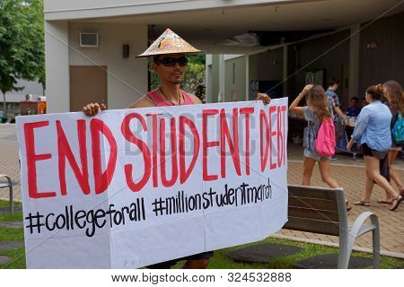 Honolulu - November 12, 2015:  Student Holds Sign Saying End Student Debt On Campus Of The Universit