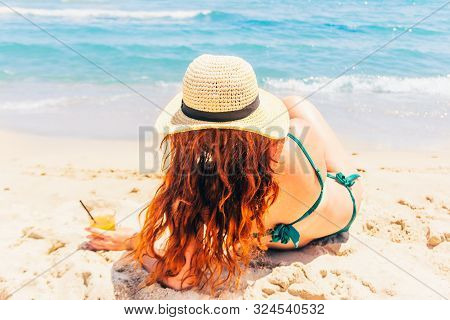 Woman On The Vaction Lying Atthe Sand Beach By The Sea