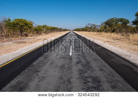 Long Tarmac Road B8 Called Golden Highway In The Caprivi Strip, Namibia, Africa Going Straight To Th