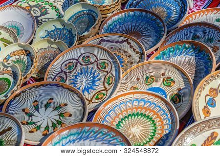 Background With Romanian Traditional Ceramic In The Plates Form, Painted With Specific Patterns From