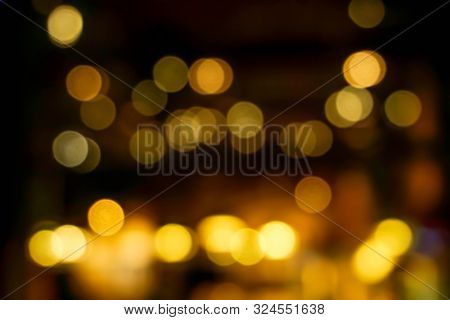 Abstract Blurred And Bokeh Light Bubs Reflection Lighting Of Small Pub In The City At The Night Time