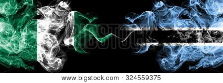 Nigeria Vs Botswana, Botswanan Abstract Smoky Mystic Flags Placed Side By Side. Thick Colored Silky 