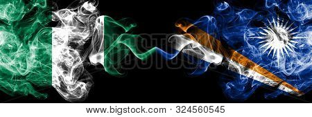 Nigeria Vs Marshall Islands Abstract Smoky Mystic Flags Placed Side By Side. Thick Colored Silky Smo