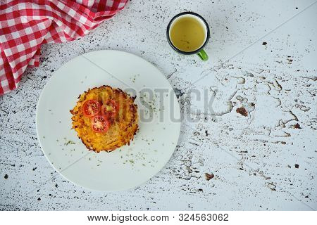 Hash Browns Or Potato Pancakes Or Swiss Rösti Garnish With Cherry Tomato And Parsley