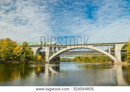 Kouvola, Finland - 25 September, 2019: Autumn Landscape Of Bridge With Passenger Train And Kymijoki 