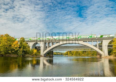 Kouvola, Finland - 25 September, 2019: Autumn Landscape Of Bridge With Moving Passenger Train And Ky
