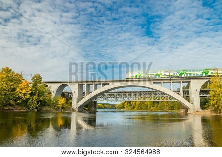 Kouvola, Finland - 25 September, 2019: Autumn Landscape Of Bridge With Moving Passenger Train And Ky
