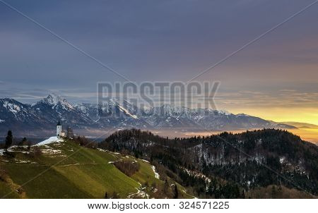 Panoramic View At St. Primus And Felician Church In Jamnik, Julian Alps, Slovenia