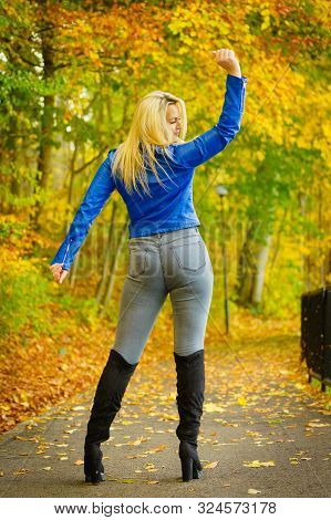 Sensual Woman Wearing Fashionable Outfit. Female Having Navy Bue Leather Jacket, Jeans And High Knee