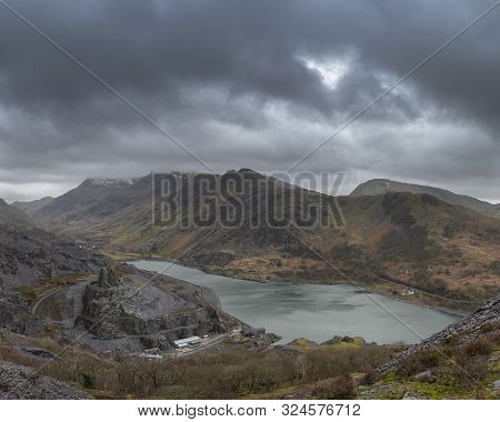 Stunning Landscape Image Of Dinorwig Slate Mine And Snowcapped Snowdon Mountain In Background During
