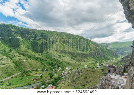 Panoramic View Of Vardzia Cave Monastery Town. View From The Monastery To The River Valley And Green