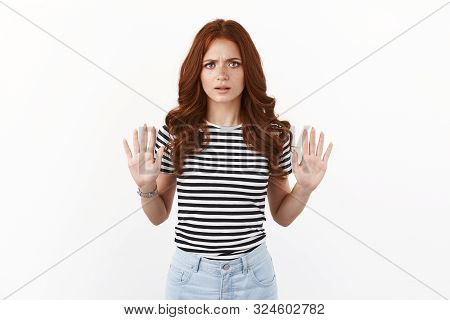 Serious-looking Annoyed And Disappointed Young Redhead Woman In Striped T-shirt Wanna Finish Convers