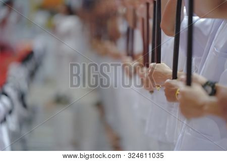 Close Up Young Asian Males Hand, They Hold Talipot Fan In The Row