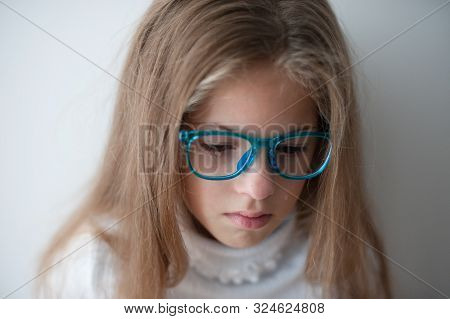 Beautiful Caucasian Little Girl In Blue Glasses Crying With Bitter Tear In Eye Being Sad And Frustra