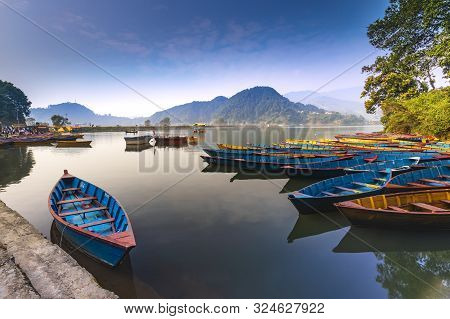 Amazing View Of Begnas Lake In Morning Light. Colorful Boats,hills And Blue Sky.nepal