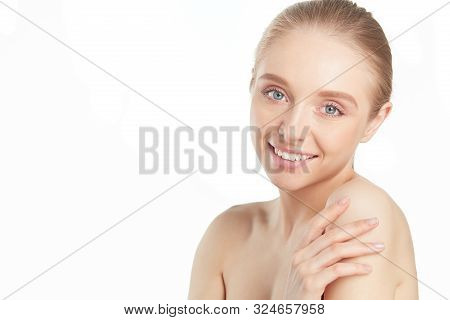 Portrait Of Beautiful Woman With Natural Make Up Touching Her Face.