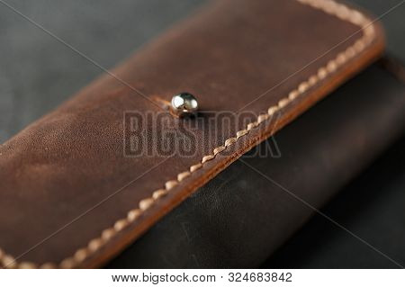 Wallet Keymaster Made Of Brown Genuine Leather, Handmade On A Dark Background