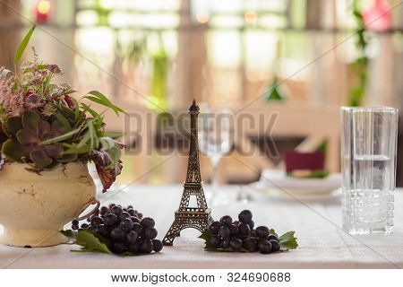 Eiffel Tower Decoration, Grapes And A Floral Arragement, Close-up. Romantic Rustic Wedding.