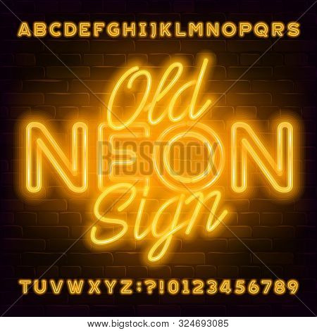 Old Neon Sign Alphabet Font. Yellow Neon Light Letters And Numbers On Brick Wall Background. Stock V