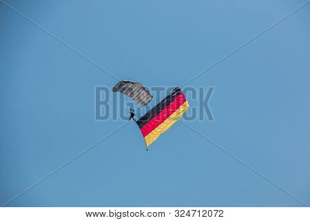 German Skydiver In The Air With German Flag