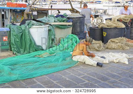 A Fisherman Repairing Fishnet, La Spezia, Italy, 5 September 2019