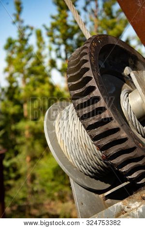 Steel Cable And Winch. Part Of An Old Winch With A Steel Rope On A Lift. Detail Of The Cableway. Clo