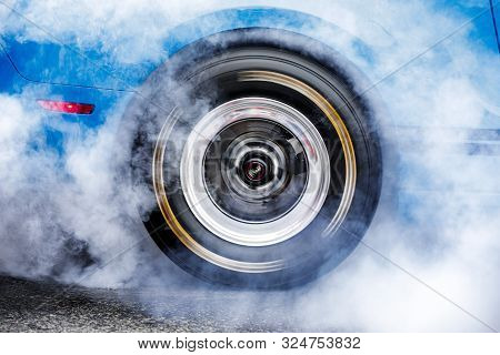 Drifting Car. Drag Racing Car Burns Rubber Off Tires Before The Start
