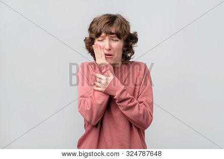 Woman Holding Her Hand On Her Aching Tooth