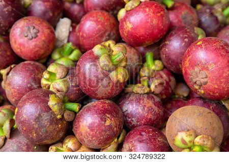 Fresh Red Mangosteen Pile On The Fruit Market Stall. Bunch Of Tropical Fruits. Ripe Mangosteen. Heal