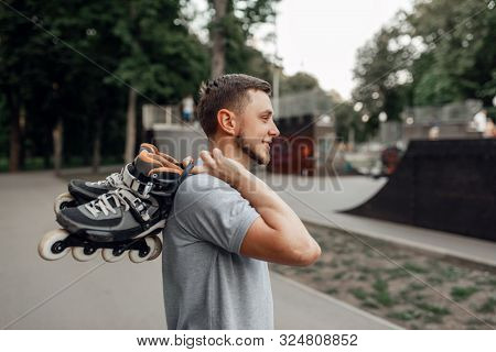 Roller skating, skater carries skates on shoulder