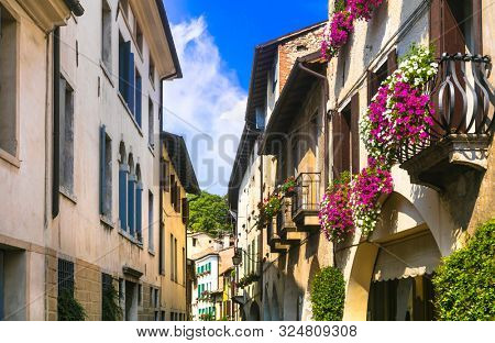 Charming floral decorated streets of medieval town Asolo in Veneto. Northern Italy