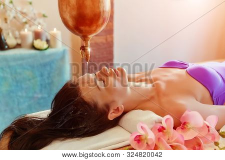 Ayurveda Massage Alternative Healing Therapy.beautiful Caucasian Female Getting Shirodhara Treatment