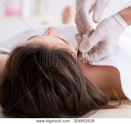 Police coroner examining dead body corpse in morgue