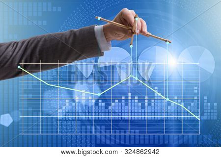 Businessman controlling the market with strings
