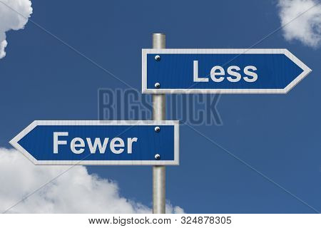 Learning To Use Proper Grammar, Blue Road Sign With Words Less And Fewer With Sky Background 3d Illu