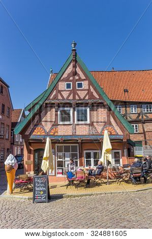Lauenburg, Germany - April 16, 2019: People Enjoying The Sun At A Cafe In Lauenburg, Germany