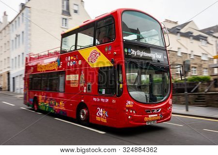 Edinburgh, United Kingdom - July 29, 2019: Quickly Driving Hop-on Hop-off Red Bus On A City Sightsee