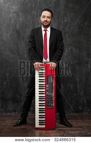 Guy With Red Electronic Piano. Music. Pianist