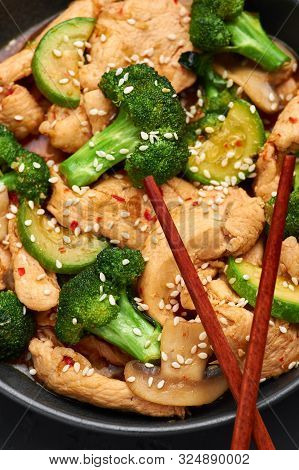 Hunan Chicken In Black Bowl At Dark Slate Background. Hunan Chicken Is Chinese Or Indo-chinese Cuisi