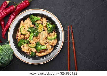 Hunan Chicken In Black Bowl At Dark Slate Background. Hunan Chicken Is Chinese Or Indo-chinese Cuisi