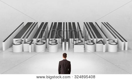 Young businessman standing in front of a big codebar