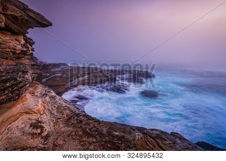 Tumultuous Waves Crash And Cascade Off The Rocks Under The Cliffs Near Sydney As A Dense Thick Fog C