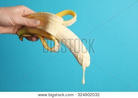 Big Banana And Drops Of Condensed Milk. Concept Of Sex, Man Ejaculation. Sperm And Orgasm.